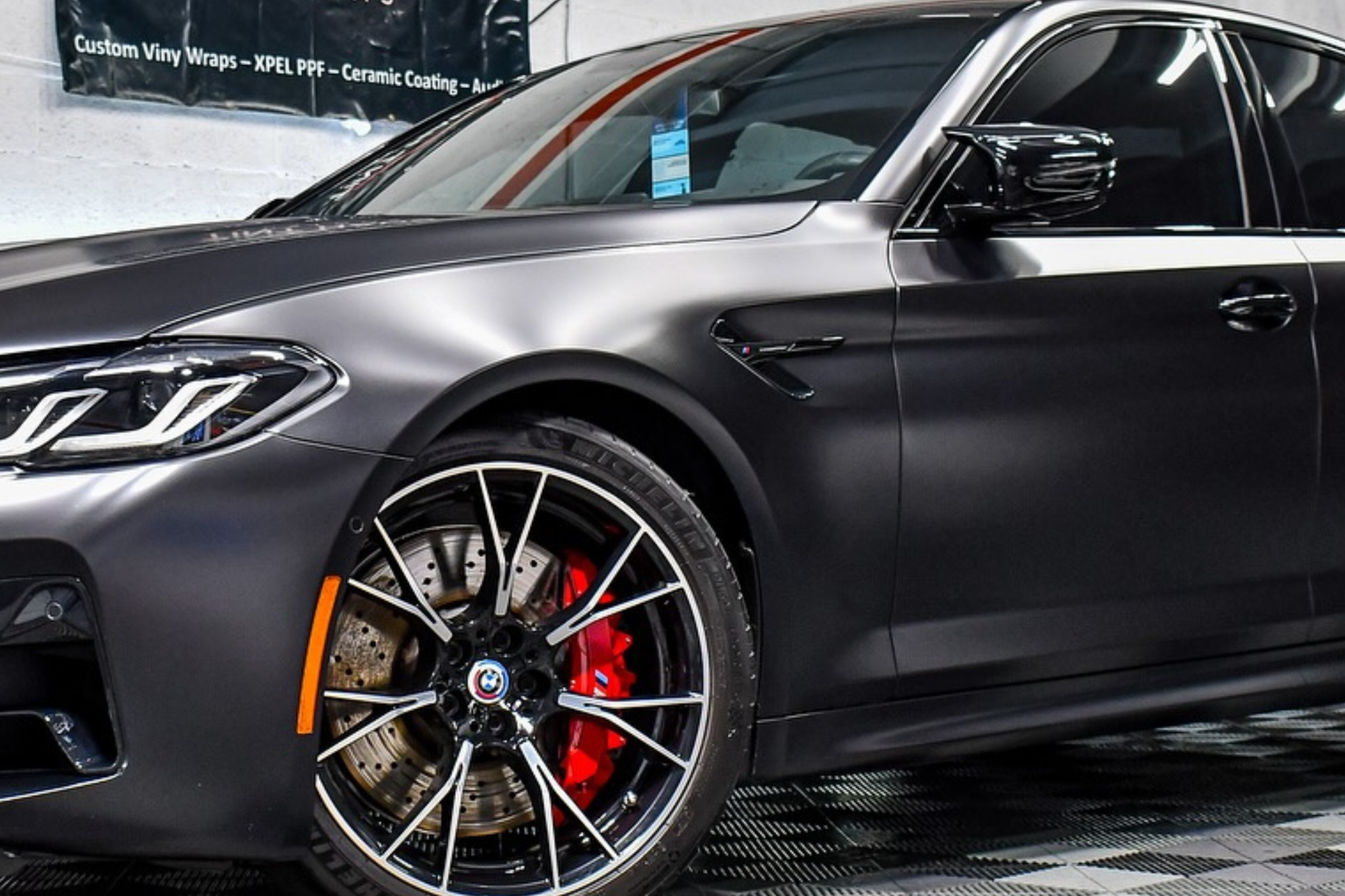 A sleek black BMW M5 parked, showcasing its elegant design and powerful stance.