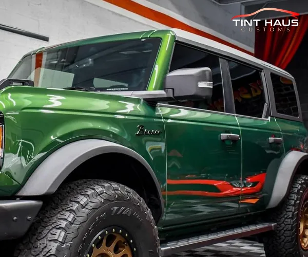 A side profile of the dark green car.